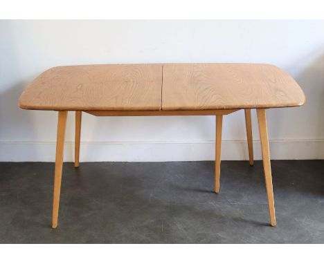 An Ercol light elm kitchen table, (with no extension leaves), H: 72cm, W: 91cm, L:153cm (approx.)