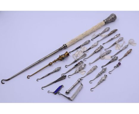 A collection of twenty-four small silver hafred pocket and other button hooks together with al large Victorian silver and ivo