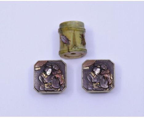 A pair of Japanese Meiji period buttons and a Japanese netsuke or toglle inlaid with insects