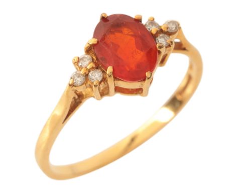 A FIRE OPAL AND DIAMOND RINGin 18ct gold, set with an oval cut fire opal of c.0.90 carats, flanked by trefoils of round brill