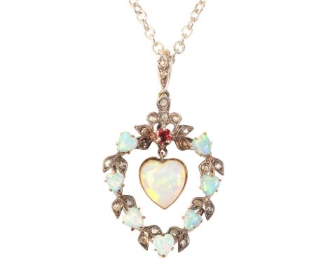 AN ANTIQUE OPAL AND DIAMOND PENDANTin silver on 9ct gold, set with an articulated heart shaped opal cabochon of c.2.50 carats