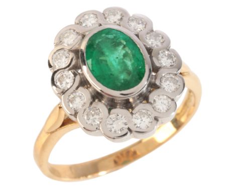 AN EMERALD AND DIAMOND CLUSTER RINGin 18ct gold, set with an oval cut emerald, held in a bezel setting, surrounded by a clust