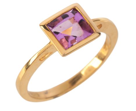 AN AMETHYST DRESS RINGin 9ct gold, set with a step cut amethyst, held in a bezel setting, full British hallmarks, stamped '9K