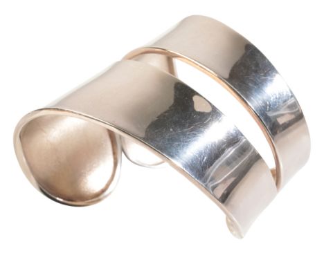 A STYLISED CUFF BANGLEin sterling silver, in a contemporary design, internal circumference c.16.3cm, (c.48.4g)