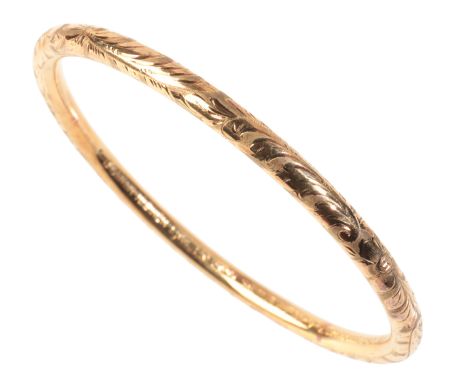 A PRE-WORLD WAR II GOLD BANGLE in 14ct gold, engraved throughout with floral details, stamped '585', internal circumference c