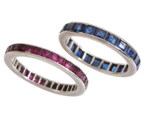 MATCHING RUBY AND SAPPHIRE ETERNITY RINGSin 18ct white gold, set respectively with calibré cut rubies and sapphires, held in 