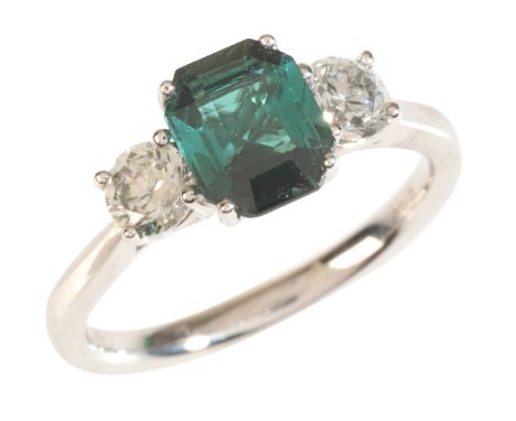 A TOURMALINE AND DIAMOND THREE STONE RINGin 18ct white gold, set with an emerald cut green tourmaline of c.1.30 carats, flank