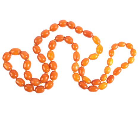 A LARGE AMBER NECKLACEcomprising a single row of fifty-five amber beads, graduating from 16.0-23.0mm, c.130.0cm / 51.2in, (c.