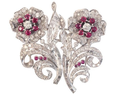 A RUBY AND DIAMOND DOUBLE CLIP FLOWER BROOCHin platinum, set with clusters of round cut rubies and round brilliant cut diamon