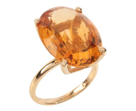 A CITRINE COCKTAIL RINGin 9ct gold, set with an oval cut citrine of c.4.26 carats, stamped '9CT', size L1/2 / 52, (c.5.9g)