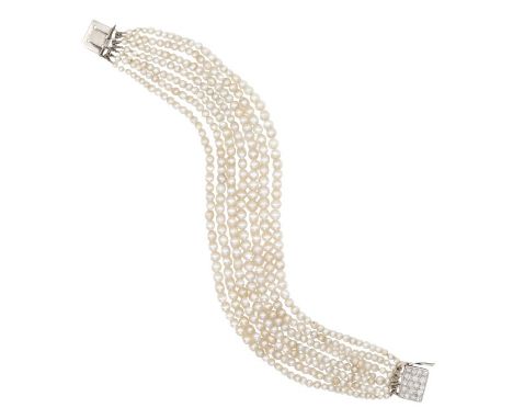 A VINTAGE PEARL AND DIAMOND BRACELETcirca 1940s, comprising seven rows of pearls, graduating from c.2.3-3.8mm, secured with a