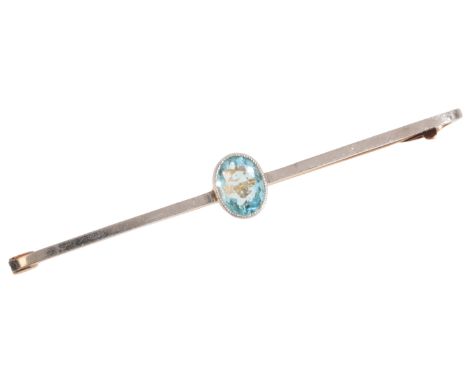 AN ANTIQUE AQUAMARINE BAR BROOCHin 15ct gold and platinum, set with an oval cut aquamarine, held in a bezel setting, secured 