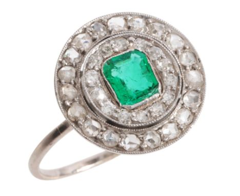 AN EMERALD AND DIAMOND CLUSTER RINGin platinum, set with a step cut emerald of c.0.50 carats, surrounded by a double halo of 