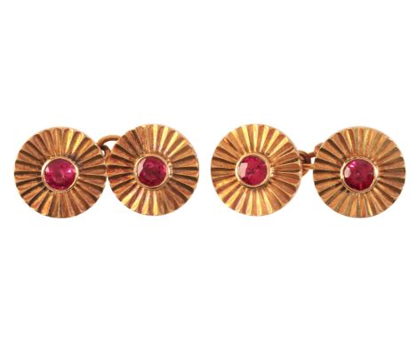 CARTIER: A PAIR OF VINTAGE BURMA RUBY CUFFLINKSin 18ct rose gold, each comprising two circular terminals, each set with a rou