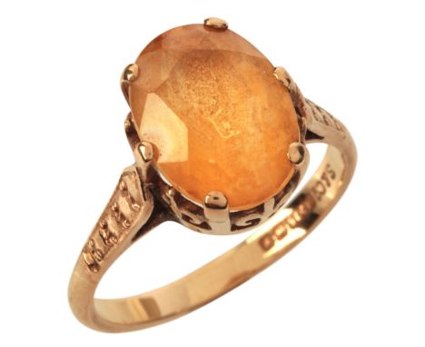 A VINTAGE CITRINE SOLITAIRE RINGin 9ct gold, set with an oval cut citrine of c.3.75 carats, held in a claw setting over a sty