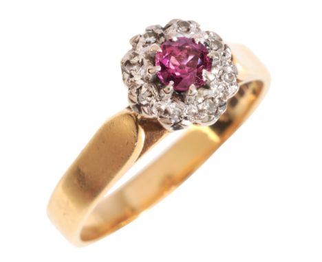 A RUBY AND DIAMOND CLUSTER RING&nbsp;in 18ct, set with a round cut ruby, surrounded by a cluster of single cut diamonds, full