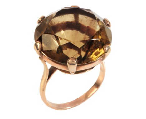 A SMOKY QUARTZ COCKTAIL RINGin 9ct gold, set with a round cut smoky quartz of c.38.80 carats, held in a claw setting, no assa