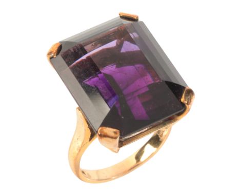 AN AMETHYST COCKTAIL RINGin 9ct gold, set with a step cut amethyst of c.26.99 carats, full British hallmarks, size J1/2 / 49.