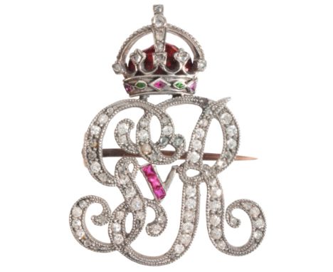 A RUBY AND DIAMOND GEORGE V CYPHER BROOCHin platinum and gold, set throughout with old mine cut diamonds and calibré cut rubi