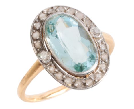 AN AQUAMARINE AND DIAMOND CLUSTER RINGin 18ct gold and platinum, set with an oval cut aquamarine of c.2.27 carats, surrounded