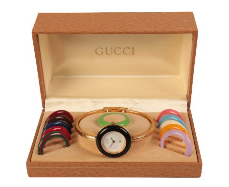 GUCCI "CHANGE": A LADY'S GOLD-PLATED BRACELET WATCHwith quartz movement, the white dial with gold hands, with twelve intercha