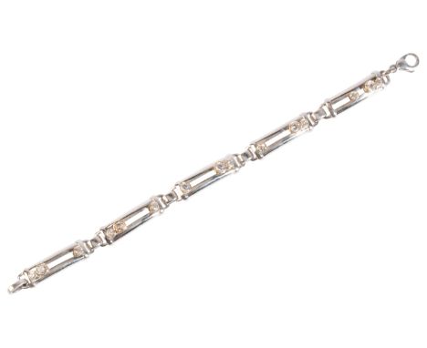 A DIAMOND BRACELETin 14ct white and yellow gold, comprising a series of curved links, each set with three graduated diamonds 