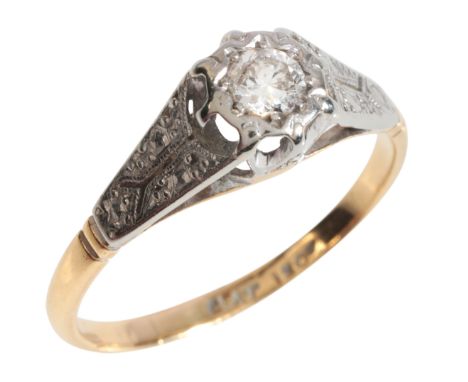 A DIAMOND SOLITAIRE RINGin 18ct gold and platinum, set with a round brilliant cut diamond, to stylised shoulders, stamped 'PL