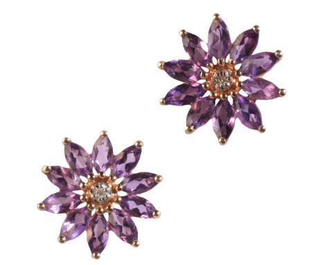 A PAIR OF AMETHYST AND DIAMOND STUD EARRINGSin 9ct gold, each designed as a flower, set with a round cut diamonds and marquis