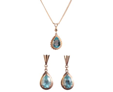 A TOPAZ PENDANT NECKLACE AND EARRING SUITEin 9ct gold, the pendant set with a pear cut blue topaz held in a bezel setting wit