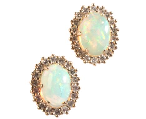 A PAIR OF OPAL AND DIAMOND CLUSTER EARRINGSin 9ct gold, each set with an opal cabochon, surrounded by a cluster of round bril