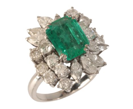 AN EMERALD AND DIAMOND CLUSTER RINGin 18ct white gold, set with a step cut emerald of c.2.14 carats, surrounded by a cluster 