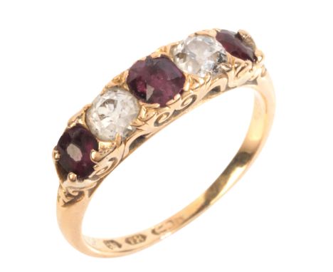 AN ANTIQUE DIAMOND AND RUBY FIVE STONE RINGin 18ct gold, set with cushion cut rubies, alternating with old mine cut diamonds,