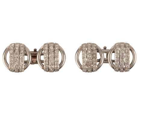 A PAIR OF VINTAGE DIAMOND CUFFLINKSin platinum, each comprising two openwork circular terminals, each overlayed with three ba