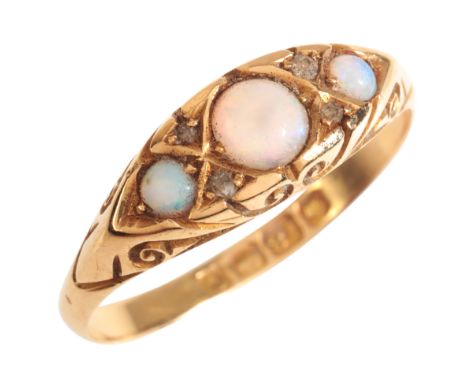 AN ANTIQUE OPAL AND DIAMOND THREE STONE RINGin 18ct gold, set with three graduated opal cabochons, accented by pairs of rose 
