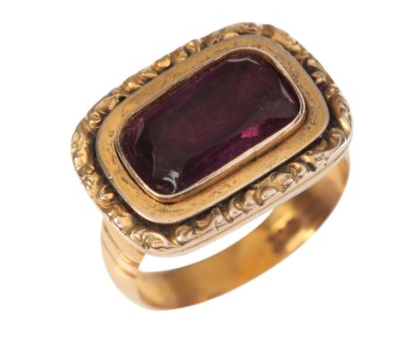 AN ANTIQUE AND LATER GARNET MOURNING RINGin 9ct gold, the antique Victorian head set with a cushion cut garnet held in a clos