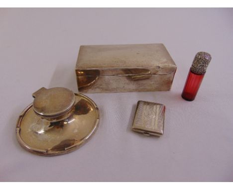 A silver capstan inkwell, a silver cigarette box, a Bryant and May silver vesta case and a ruby glass octagonal perfume bottl