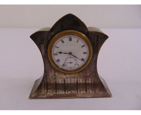 A silver mounted desk clock of rectangular form engine turned, white enamel dial, Roman numerals with subsidiary seconds, Bir