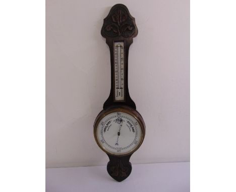 An oak cased wall mounted banjo barometer and thermometer