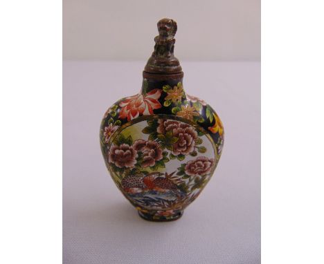 A Chinese enamel snuff bottle decorated with birds, flowers and leaves