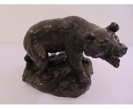 A bronzed figurine of a bear on naturalistic base, indistinctly signed to the base