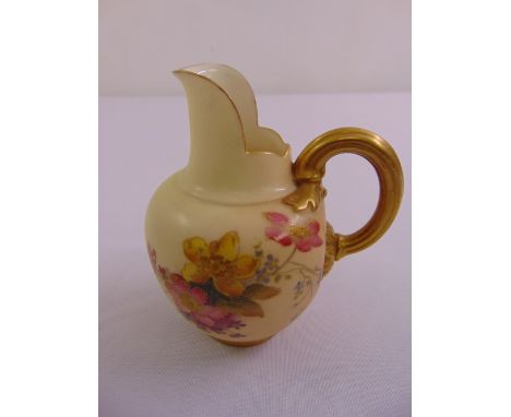 A Royal Worcester blush ivory hand painted jug with gilded handle numbered 29115/1094