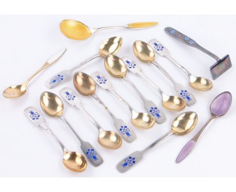 Collection of various silver and enamel spoons.