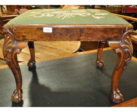 A walnut dressing stool with tapestry seat and shell carved cabriole legs,
with claw and ball feet, width 1'11", height 17", 