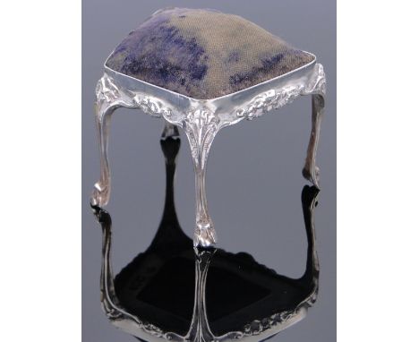 An Edwardian silver pin cushion in the form of a dressing stool,
by William Comyns, Birmingham 1905, width 5.5cm.