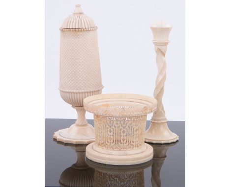 An Anglo-Indian ivory pot and cover,
height 7.25", a finely carved ivory pot and a candlestick.