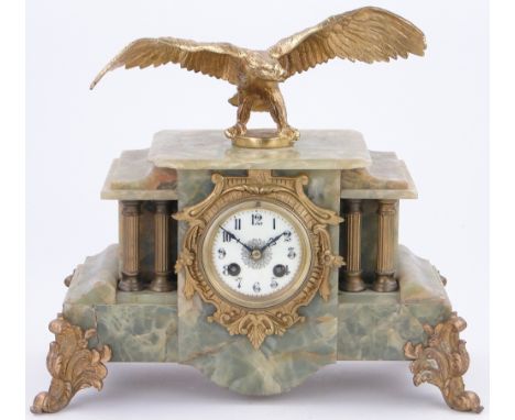 A 19th century gilded marble mantel clock,
surmounted by a gilt bronze eagle, 15" across.