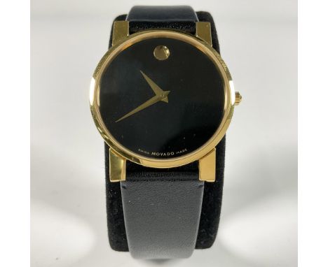 Elegant Movado Museum Classic gentlemen watch with sapphire crystal dot, black face and leather band, gold-tone stainless ste