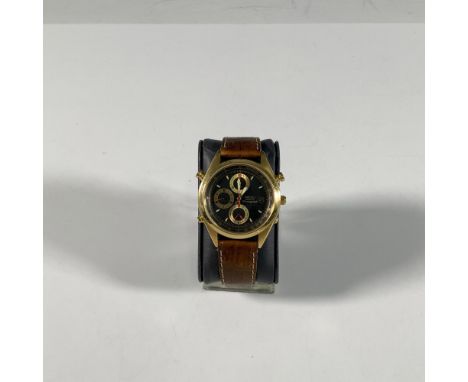 This watch has a gold tone stainless steel case with a fixed tachymeter bezel, three subdials, Japan movement, and scratch re