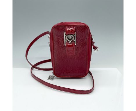 This red pebble leather bag combines the compact style of a camera bag with the functionality of a wallet and purse. It featu