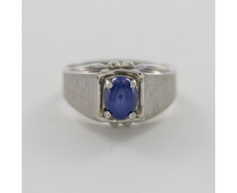 Sterling silver band with a round oval blue star sapphire cabochon. Sterling mark inside the band. Size 9. Dimensions: See De